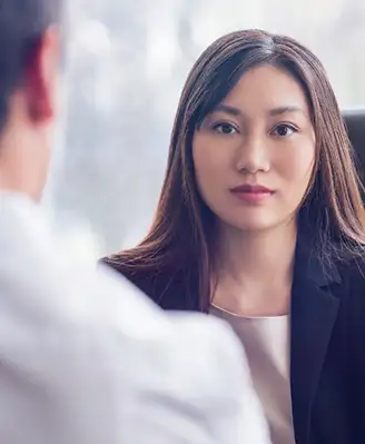 Woman with a stoic, focused look on her face having a conversation
