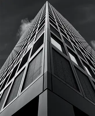 Looking up at a skyscraper in black and white